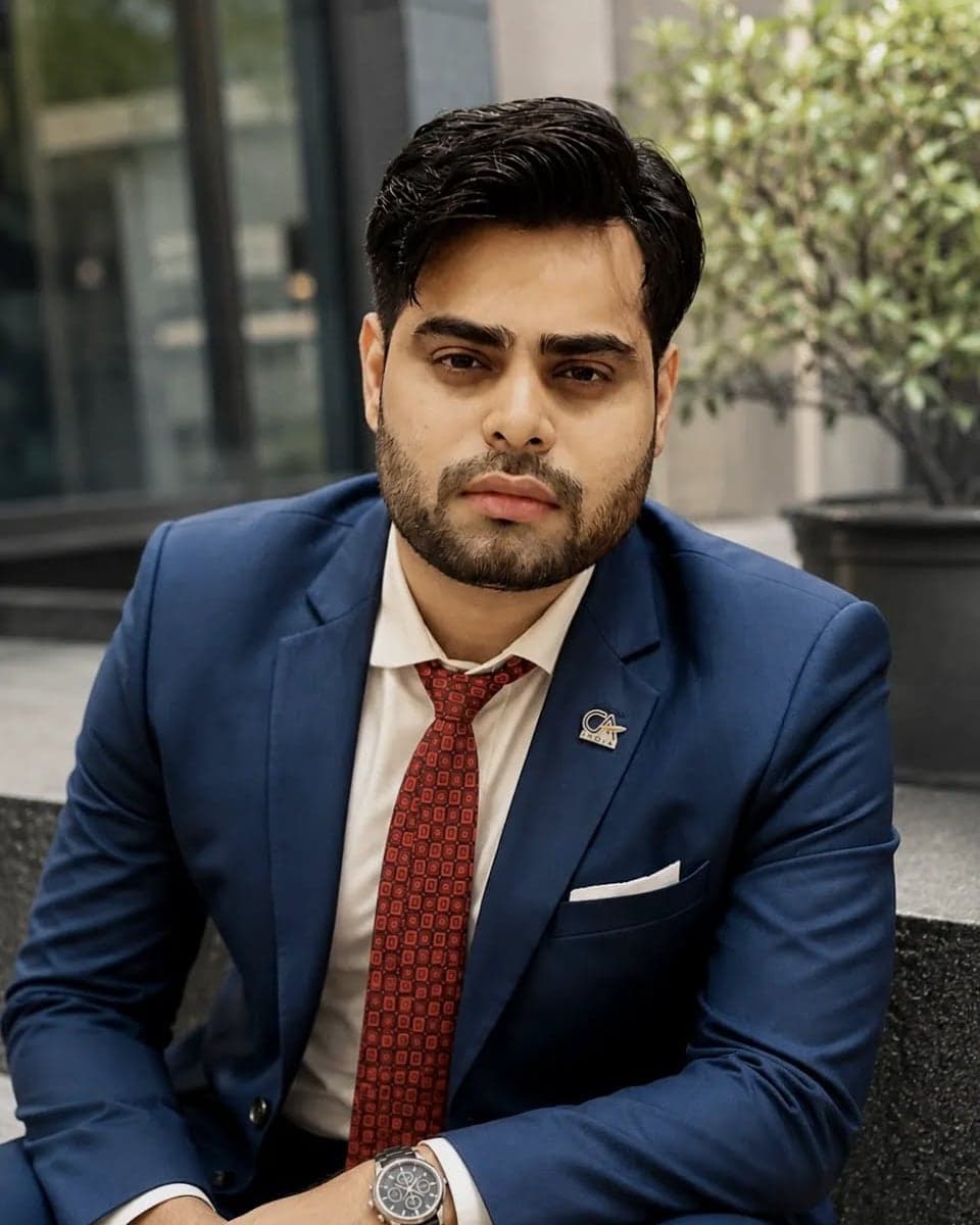 Satyam Mehta, Senior Manager of Finance & Accounts at Pelocal, in a blue suit and patterned red tie outside the office.
